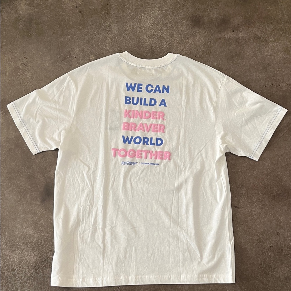 Born This Way: White Graphic Tee "We Can Build a Kinder Braver World Together"